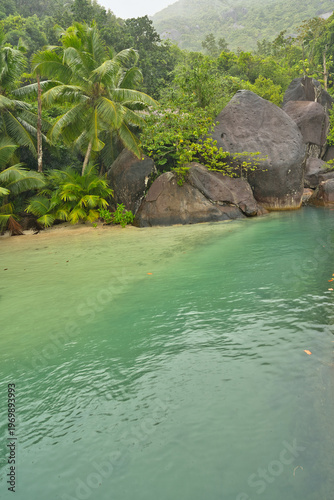 Beautiful small beach with granite stones and white sandy beach at cap ternay, Mahe, Seychelles