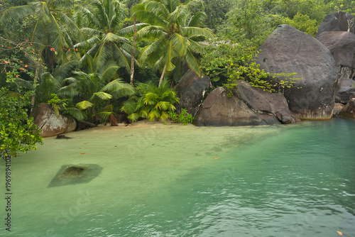 Beautiful small beach with granite stones and white sandy beach at cap ternay, Mahe, Seychelles