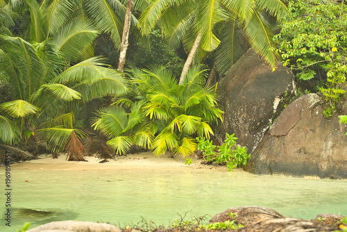 Beautiful small beach with granite stones and white sandy beach at cap ternay, Mahe, Seychelles