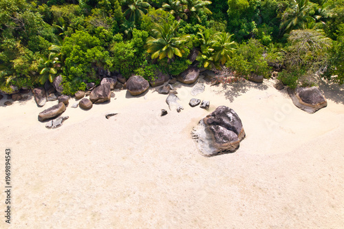 Bird eye drone of cap ternay beach, white sands, granites rocks and forest, Mahe, Seychelles