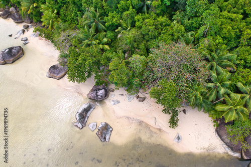 Bird eye drone of cap ternay beach, white sands, granites rocks and forest, Mahe, Seychelles