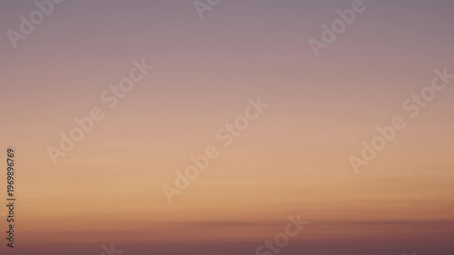 Minimal gradient sunset sky over ocean horizon with soft warm tones
