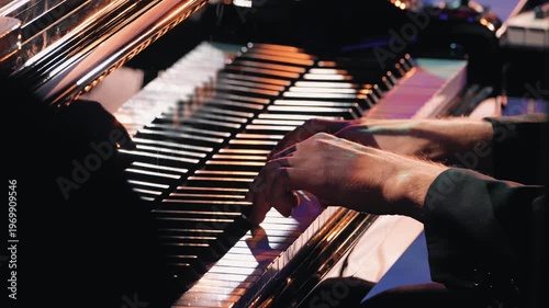 Hands of a musician playing a grand piano at a live show. Warm, dramatic stage lighting creates a soulful and intimate mood. Close-up composition, ideal for jazz or classical music concepts