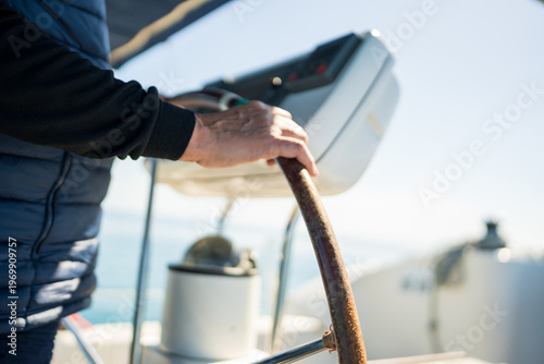 Принти на полотні Hand steering sailboat wheel on ocean voyage