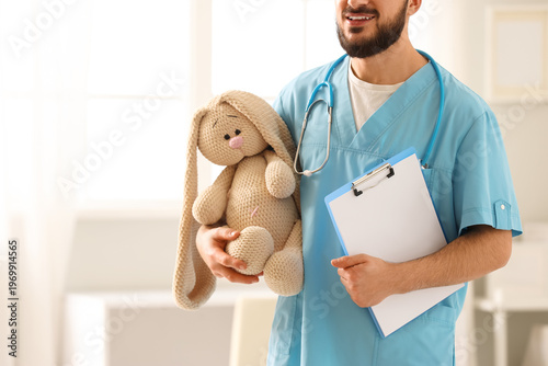 Male pediatrician with toy ...