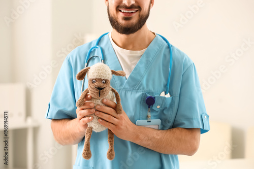 Male pediatrician with toy ...