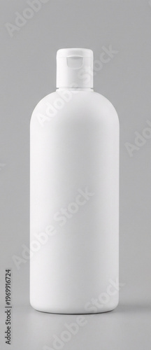 Empty white plastic bottle with a pump dispenser top isolated on gray background