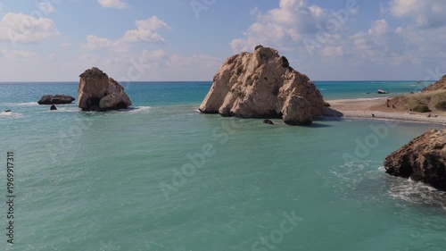 Aerial drone view of Aphrodite's Rock coastline with turquoise water and rugged cliffs along the Mediterranean shore