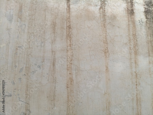 Close-up of a Severely Damaged Wall with Large Areas of Peeling Paint and Exposed Dark Concrete Layers
