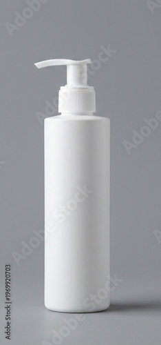 Empty white pump bottle with transparent nozzle isolated on gray background