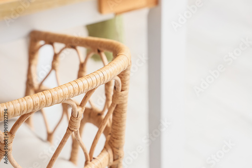 Stylish wicker chair near d...