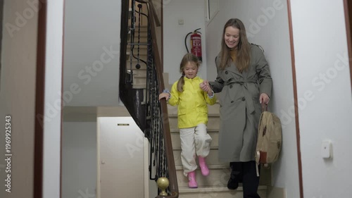 Mother and daughter sharing a goodbye moment before beginning the school day