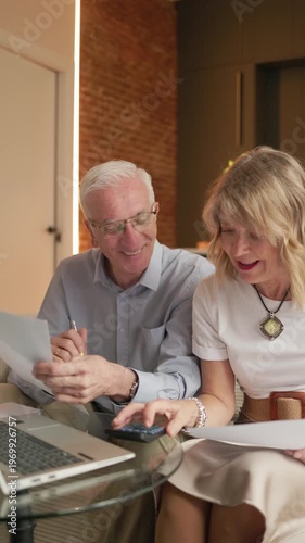 Senior couple calculating retirement pension budget financials at home