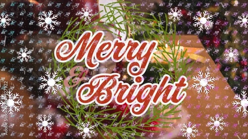 Animation of merry and bright over snowflakes, shapes and table with christmas dinner