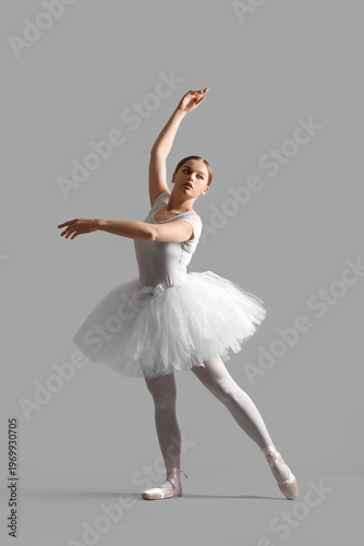 Young ballerina on grey bac...