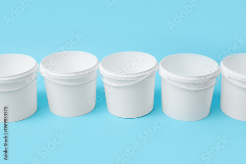 Many open plastic paint buc...