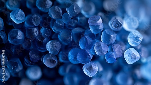 Recycled plastic pellets macro with translucent polymer granules and industrial material background
