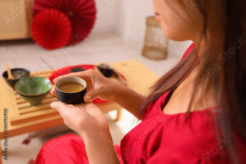 Young Asian woman with cup ...
