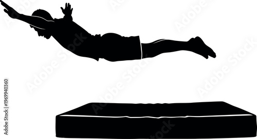 Silhouette of a person jumping onto a mattress
