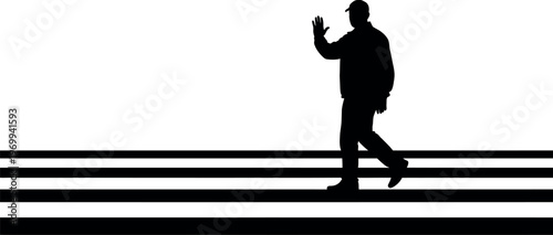 Silhouette of a man walking across a crosswalk
