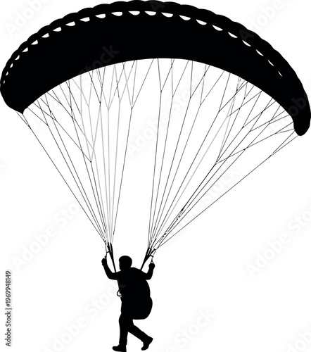 Silhouette of a person paragliding with a parachute