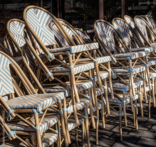 Bistro chairs stacked outsie a cafe