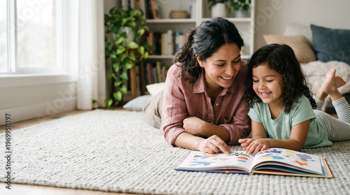 Hispanic mother and daughter reading a book together lying on a living room rug.