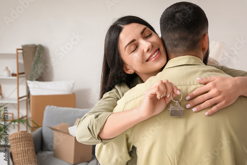 Happy young woman with key ...