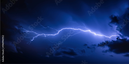 A powerful bolt of electric lightning flashes across the dark blue night sky during a dangerous thunderstorm as bright energy strikes through the heavy clouds and rain