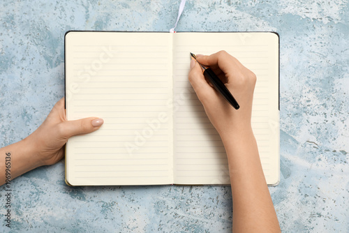 Hands with notebook and pen...