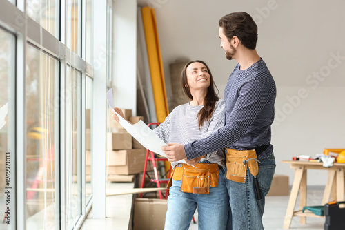 Young couple with plan near...