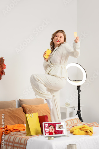 Happy young woman with mobi...
