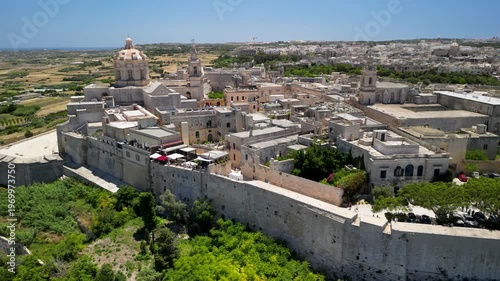drone view of Mdina fortress, Malta, old town surrounded by fields, no people