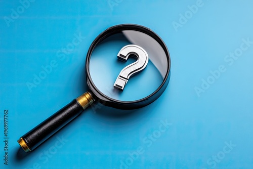 Magnifying glass examining a shiny silver question mark on a vivid blue backdrop