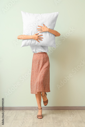 Woman holding white pillow ...