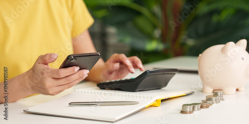 Fotografía Woman managing finances with phone and calculator