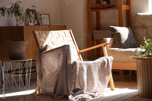 Wooden armchair with plaid ...