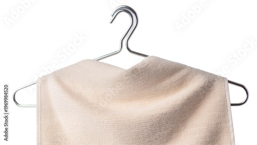 Folded beige terrycloth towel neatly draped, suspended on sleek metal hangers