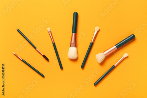 Makeup brushes on orange ba...