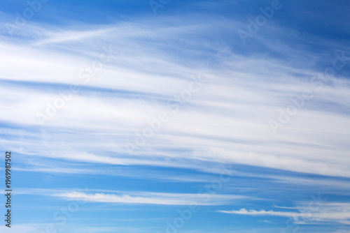 Celestial landscape of dense stratus clouds in a blue sky. Stratus clouds before a weather change. Natural background of different shades of blue. Weather forecast