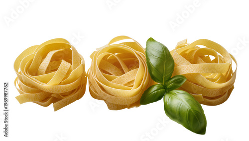 Tableau sur toile Golden egg fettuccine pasta swirls, complemented by vibrant green basil leaves