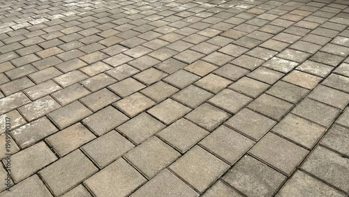 Top view of the surface of a pedestrian path with paving slabs. New cobblestone pavement close up. Traditional stone pavement. 