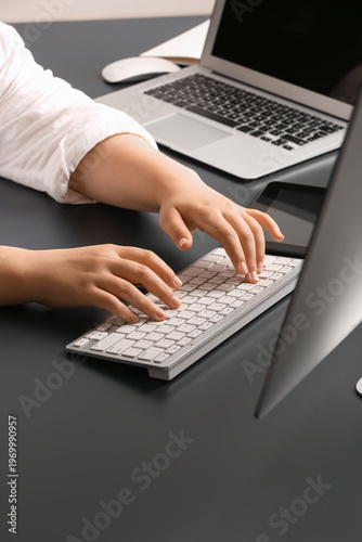 Female programmer typing on...