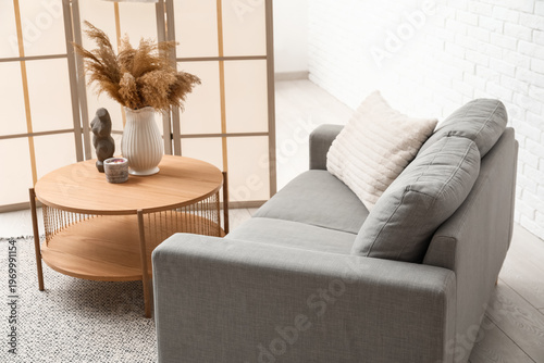 Cozy grey sofa with pillow,...