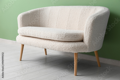 Cozy white sofa near green ...