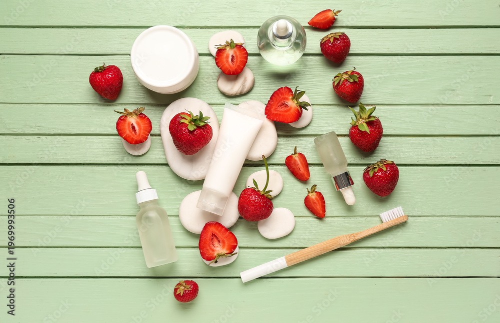 Fototapeta premium Different cosmetic products and strawberries on green wooden background