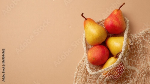 Fresh pears and one red fruit in a white mesh shopping bag, representing sustainable living and natural choices food healthy