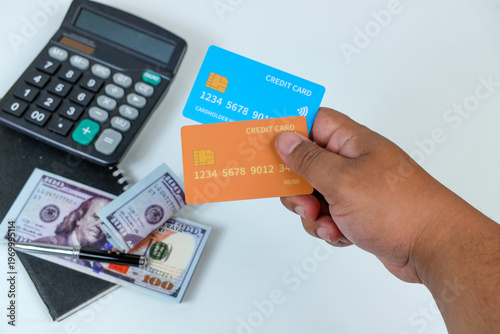 Canvastavla Hand holding credit cards with calculator and dollar bills for financial plannin