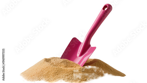 Obraz na plátne Magenta plastic shovel digging into tan granular sand, creating a small mound