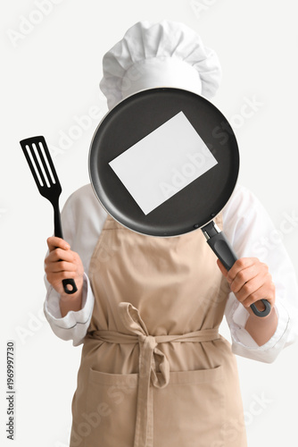 Female chef holding frying ...